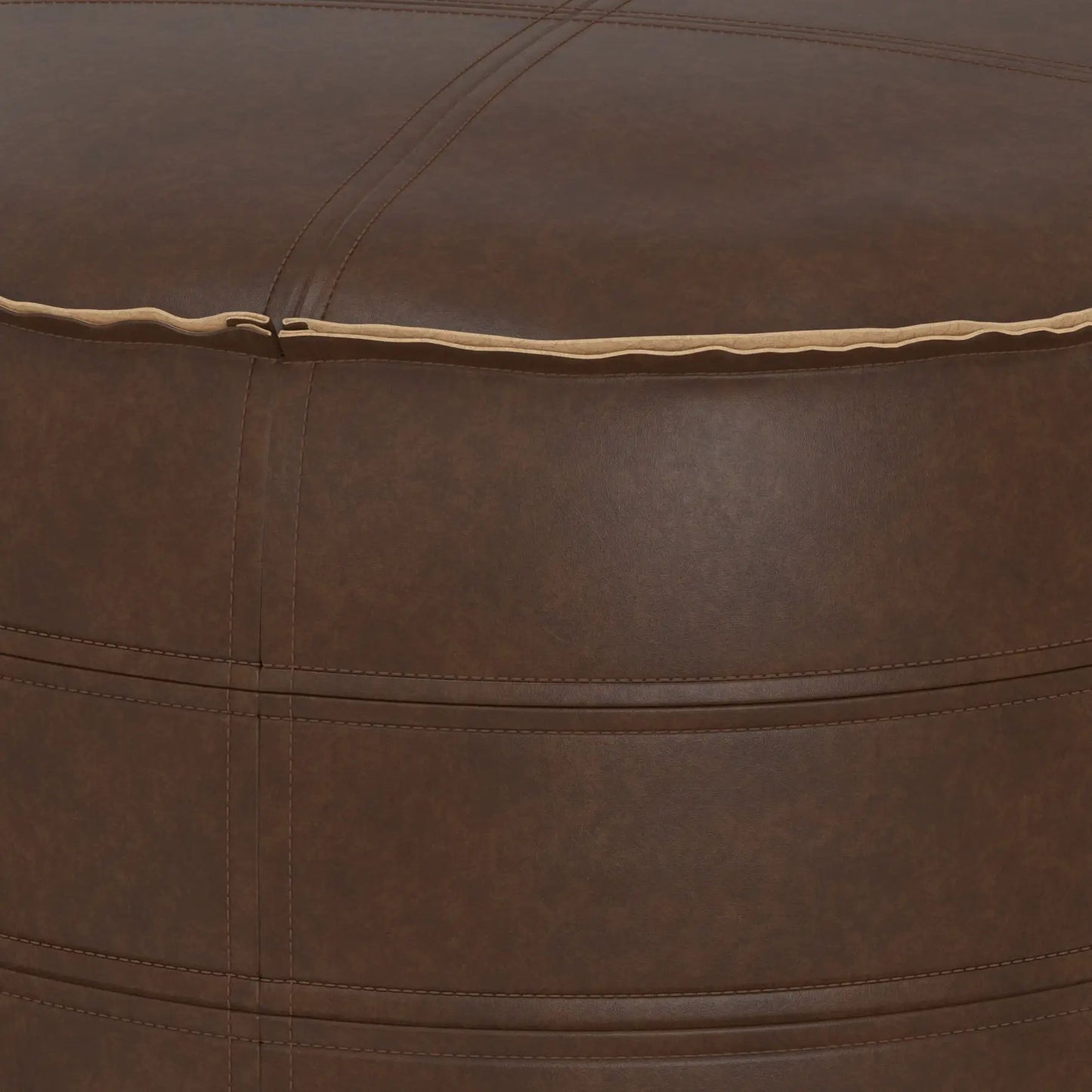 Brody round pouf leather upholstery in rich brown with tan piping and visible stitching on Tampa Home & Garden Store