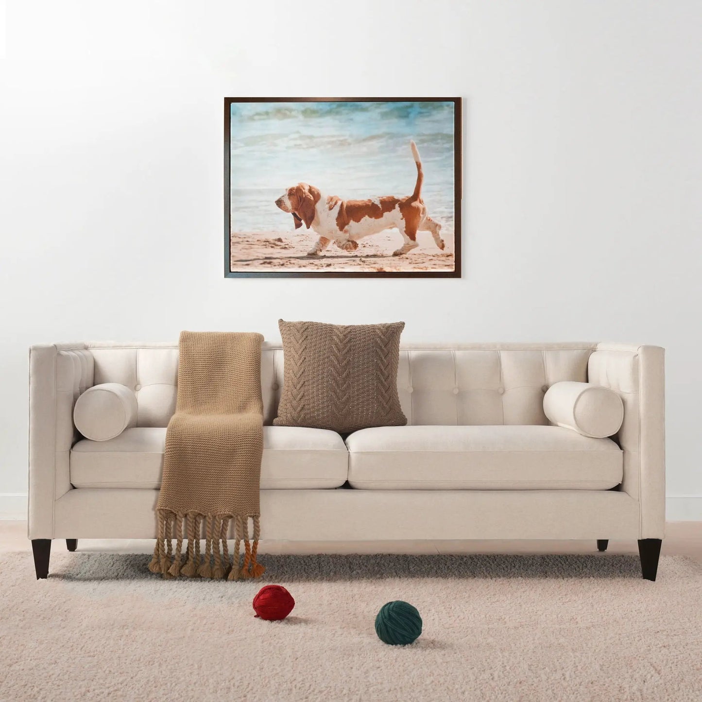 Jack Modern Tuxedo Tufted Sofa beige upholstery with two brown knit throws on Tampa Home & Garden Store