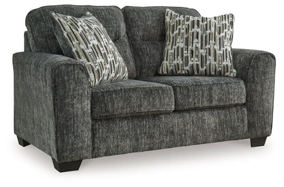 Lonoke stationary loveseat in dark gray fabric with geometric pillows on Tampa Home & Garden Store