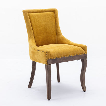 Mustard yellow upholstered side dining chair with nailhead trim and solid wood legs on Tampa Home & Garden Store