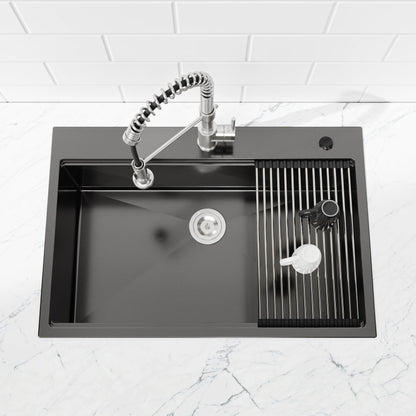 Stainless steel pull-down kitchen faucet with coiled hose over black sink with drain rack on Tampa Home & Garden Store
