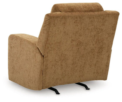 Kanlow rocker recliner in tan fabric with cushioned back and arms on metal rocker base on Tampa Home & Garden Store