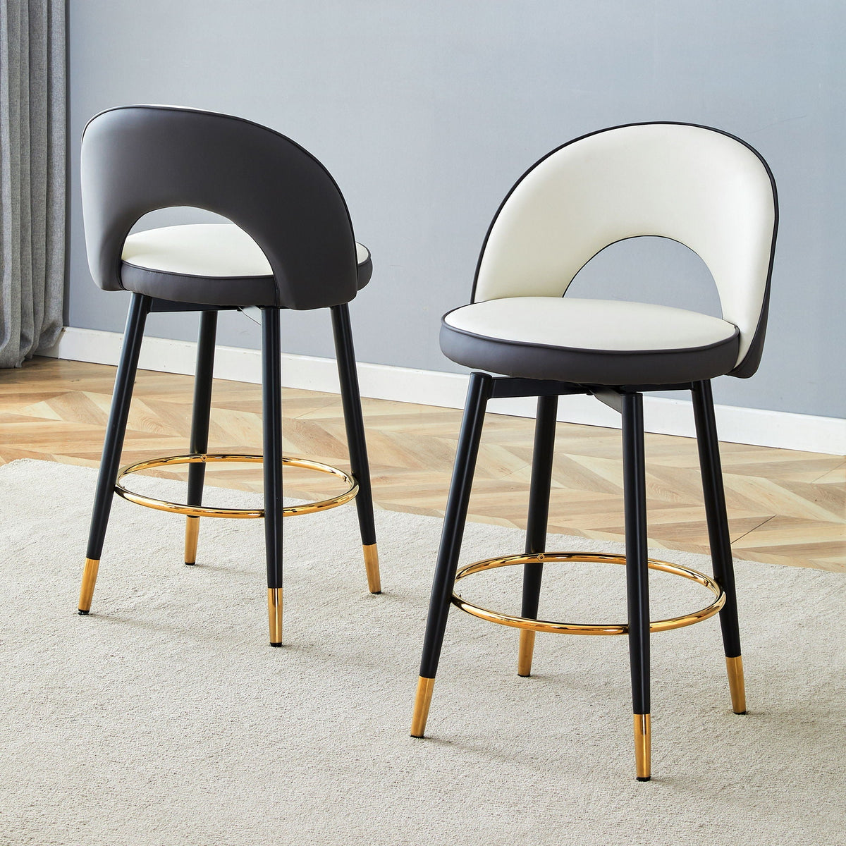Pair of upholstered rotatable bar chairs with black and white seats and gold ring footrests on Tampa Home & Garden Store