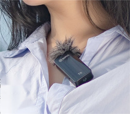 Clip-on lavalier microphone with furry windscreen clipped to a light blue shirt on Tampa Home & Garden Store