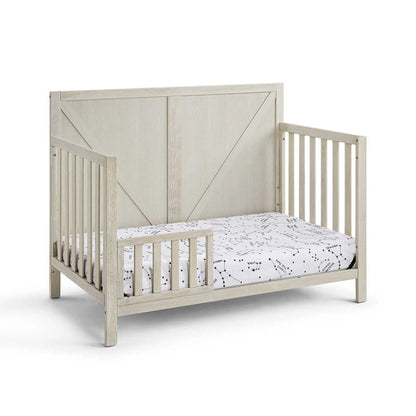 Barnside 4-in-1 Convertible Crib by Unique Piece Furniture in light-washed wood with slatted sides on Tampa Home & Garden Store