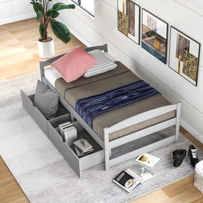 Platform bed with 2 gray under-bed drawers, gray bedding, plant by white paneled wall on Tampa Home & Garden Store