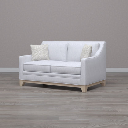 Gray stationary loveseat with durable fabric and 2 beige textured pillows on Tampa Home & Garden Store