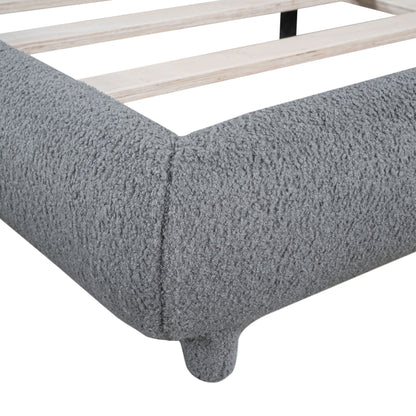 Upholstered platform bed with thick light-wood slat frame and curved foot, shown on shag rug on Tampa Home & Garden Store