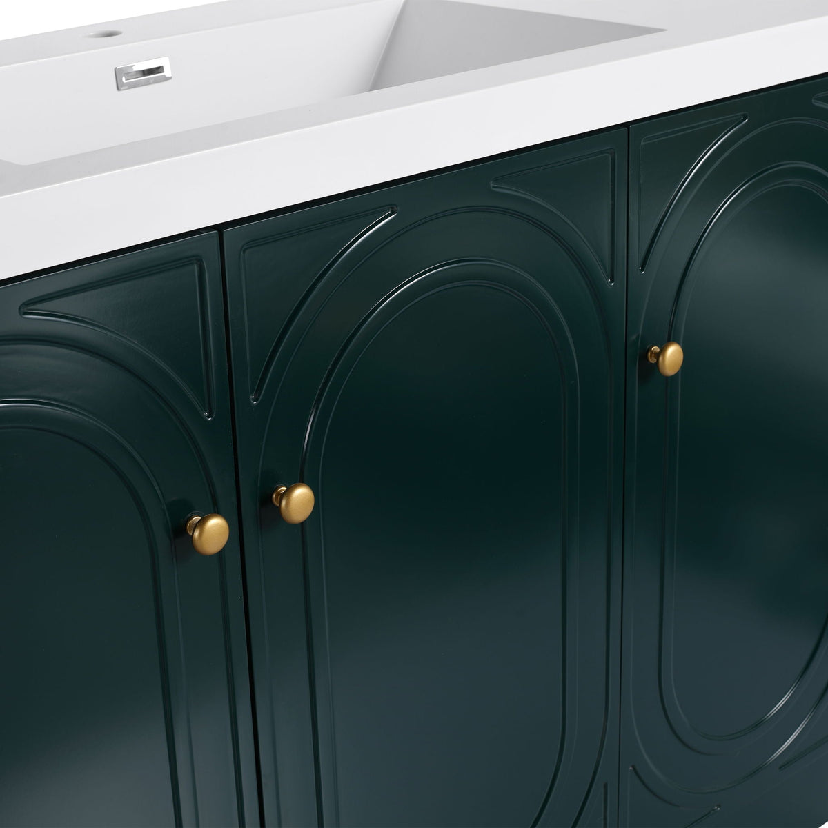 Freestanding bathroom vanity with white top and dark green arched-panel cabinets, brass knobs on Tampa Home & Garden Store