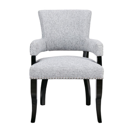 Elegant arm dining chair in gray textured fabric with nail head detailing and black legs on Tampa Home & Garden Store