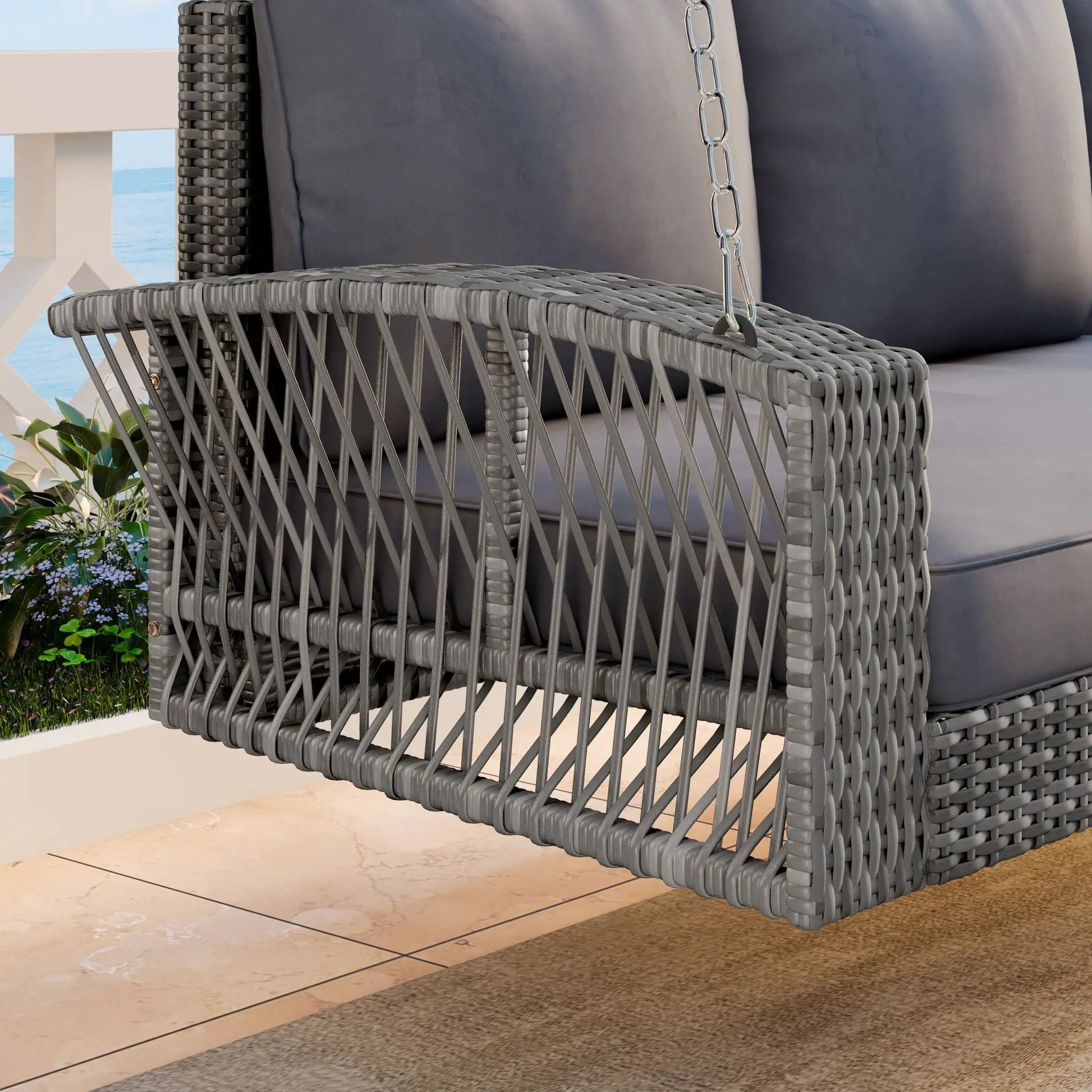 Gray wicker 3-person patio swing bench with dark cushions on outdoor deck by the sea on Tampa Home & Garden Store