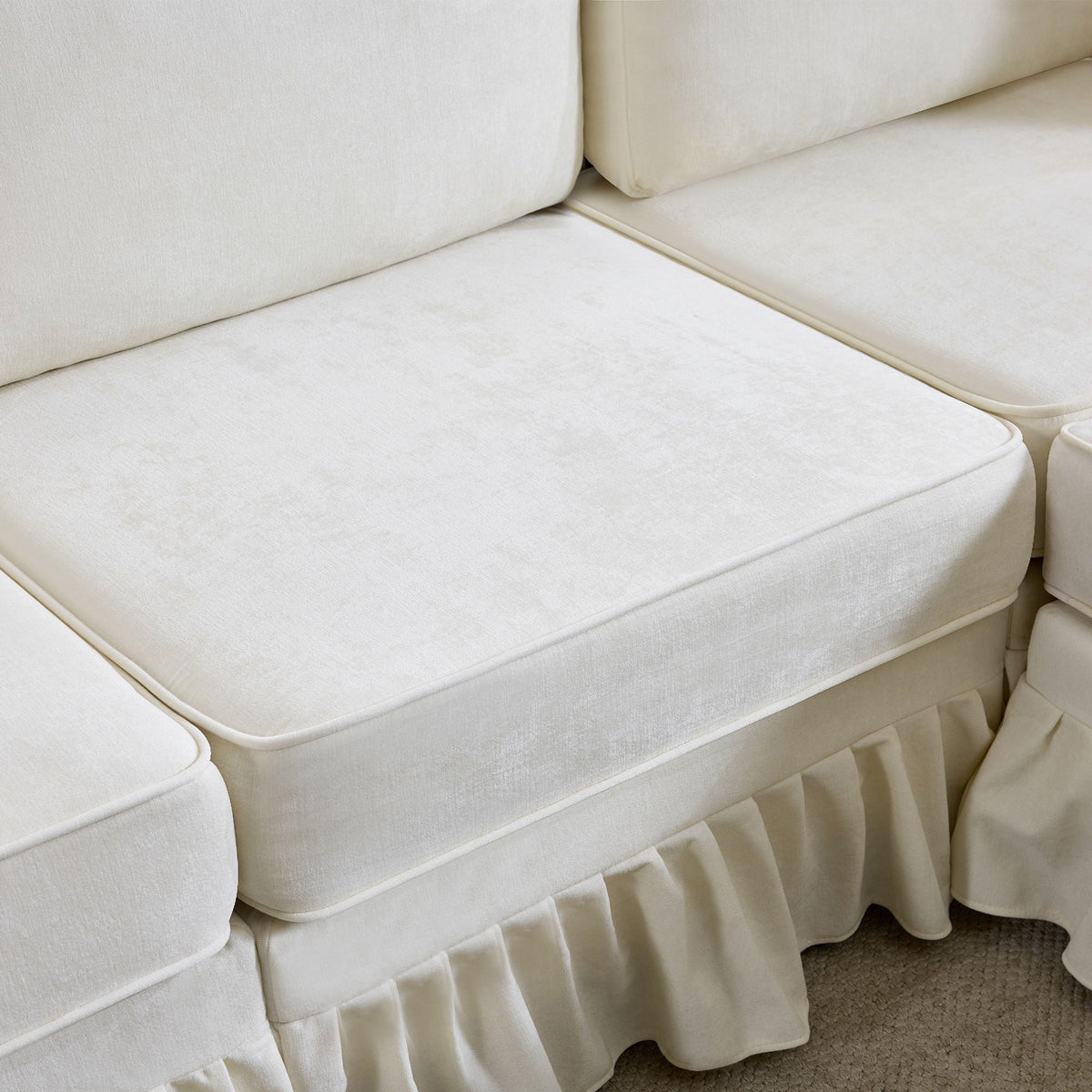 White fabric L-shaped sectional sofa with removable ruffled skirt and pleated base on Tampa Home & Garden Store