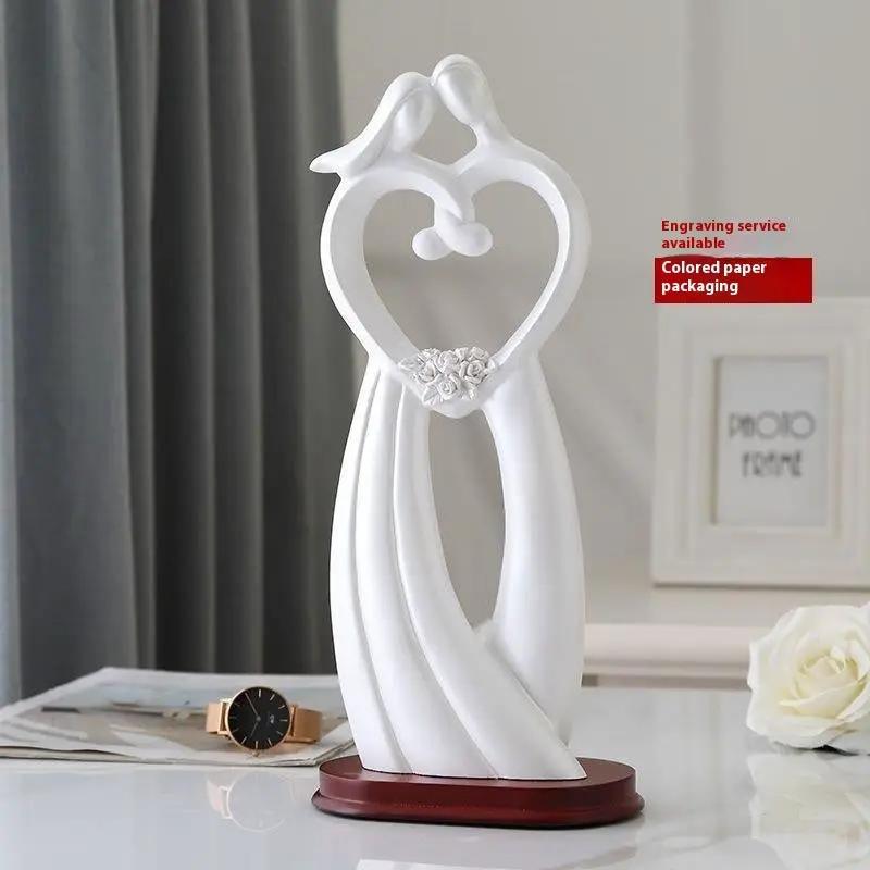 FLIPSTYLEZLLC white Valentine couple sculpture forming a heart on a wooden base on Tampa Home & Garden Store