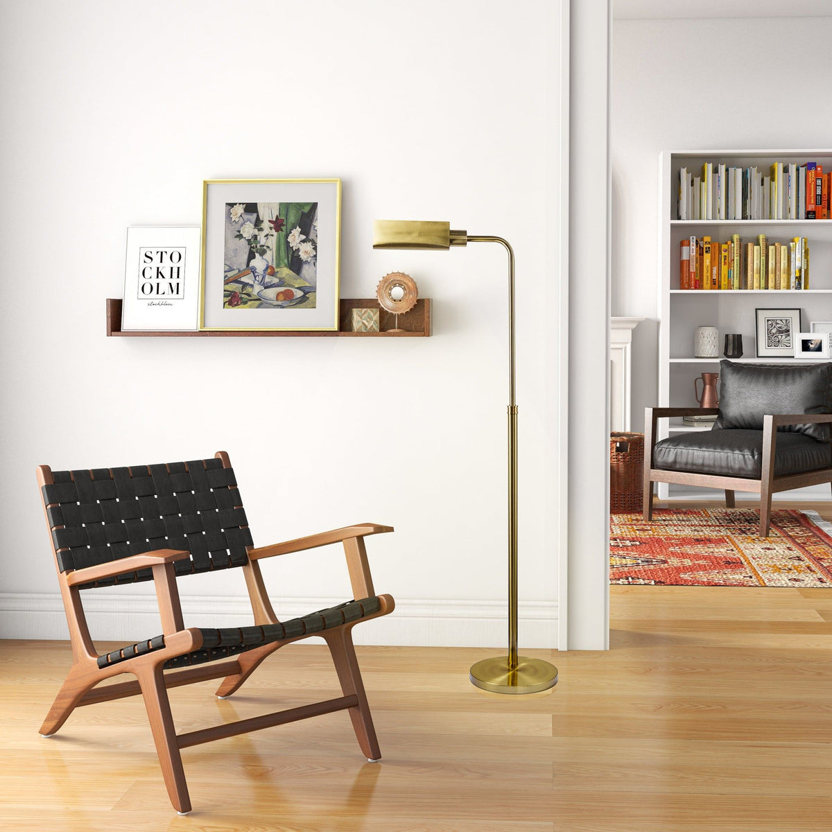Elara gold floor lamp with curved stem and rectangular shade beside framed art on wall shelf on Tampa Home & Garden Store
