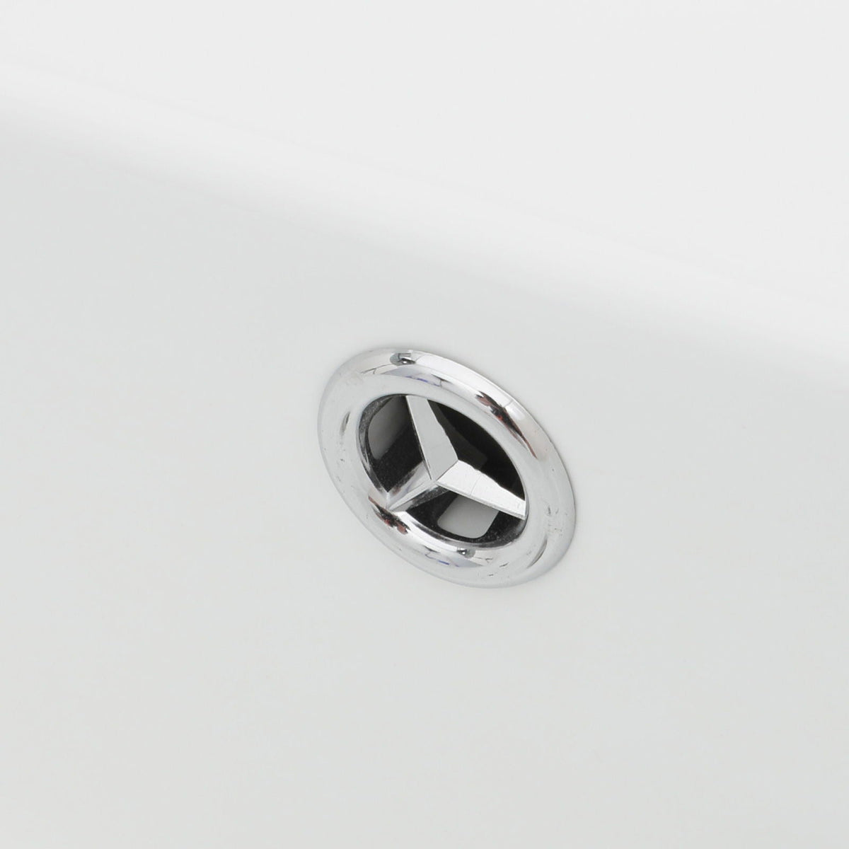 Chrome drain ring with inner strainer on white bathroom sink surface, close-up view on Tampa Home & Garden Store