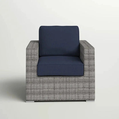 Patio arm chair with navy cushions in a gray woven rattan frame on Tampa Home & Garden Store