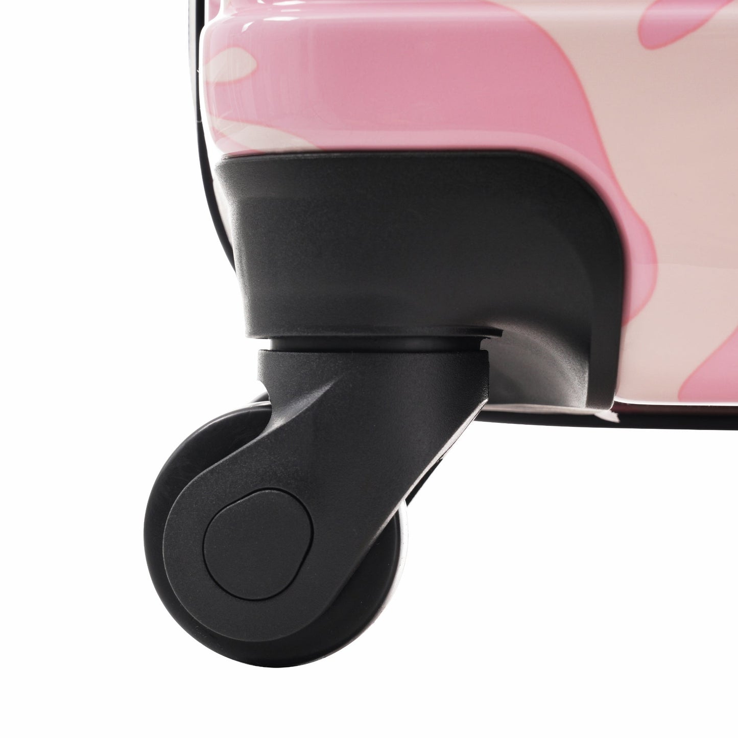 Hardshell luggage wheel close-up on pink case with black spinner wheel on Tampa Home & Garden Store