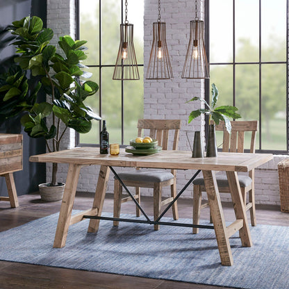 Rustic dining table with natural pine finish and metal support, industrial trestle legs on Tampa Home & Garden Store