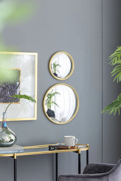 Round wall mirrors with gold iron frames, two vertically stacked circular mirrors on a gray wall on Tampa Home & Garden Store