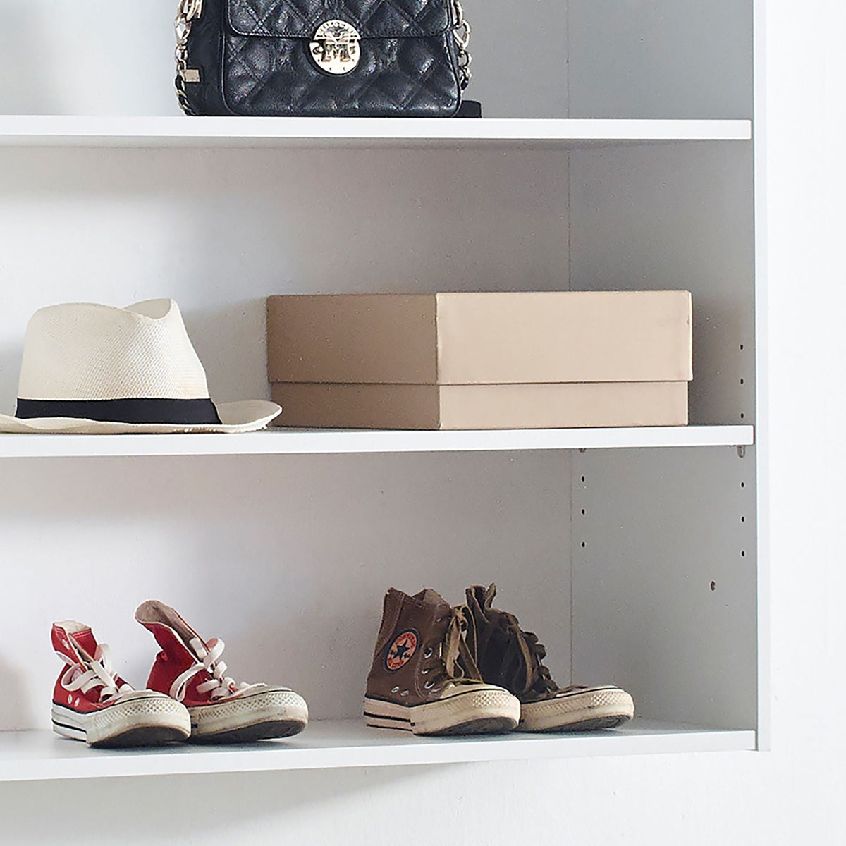 Wall Mounted Wood Closet System on white shelf with a black handbag and two sneaker pairs on Tampa Home & Garden Store