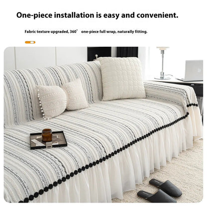 Striped sofa cover with white pleated skirt and black pom-pom trim, beige cushions on a sofa on Tampa Home & Garden Store