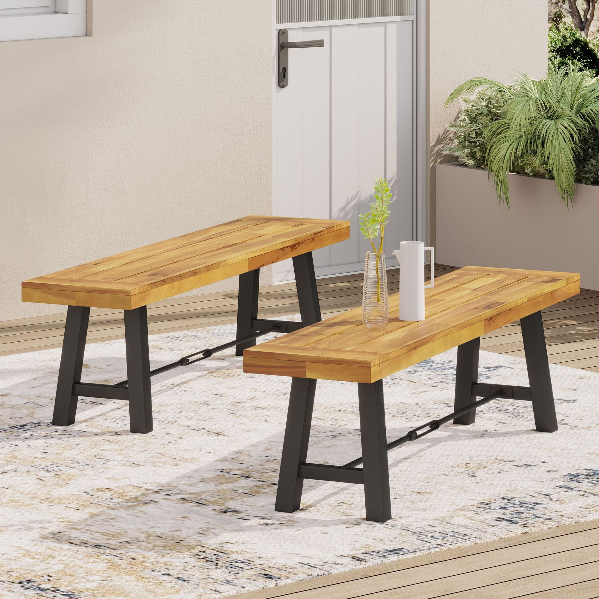 Catriona teak bench by HouseOfZazla with black metal legs, two outdoor benches on a deck on Tampa Home & Garden Store