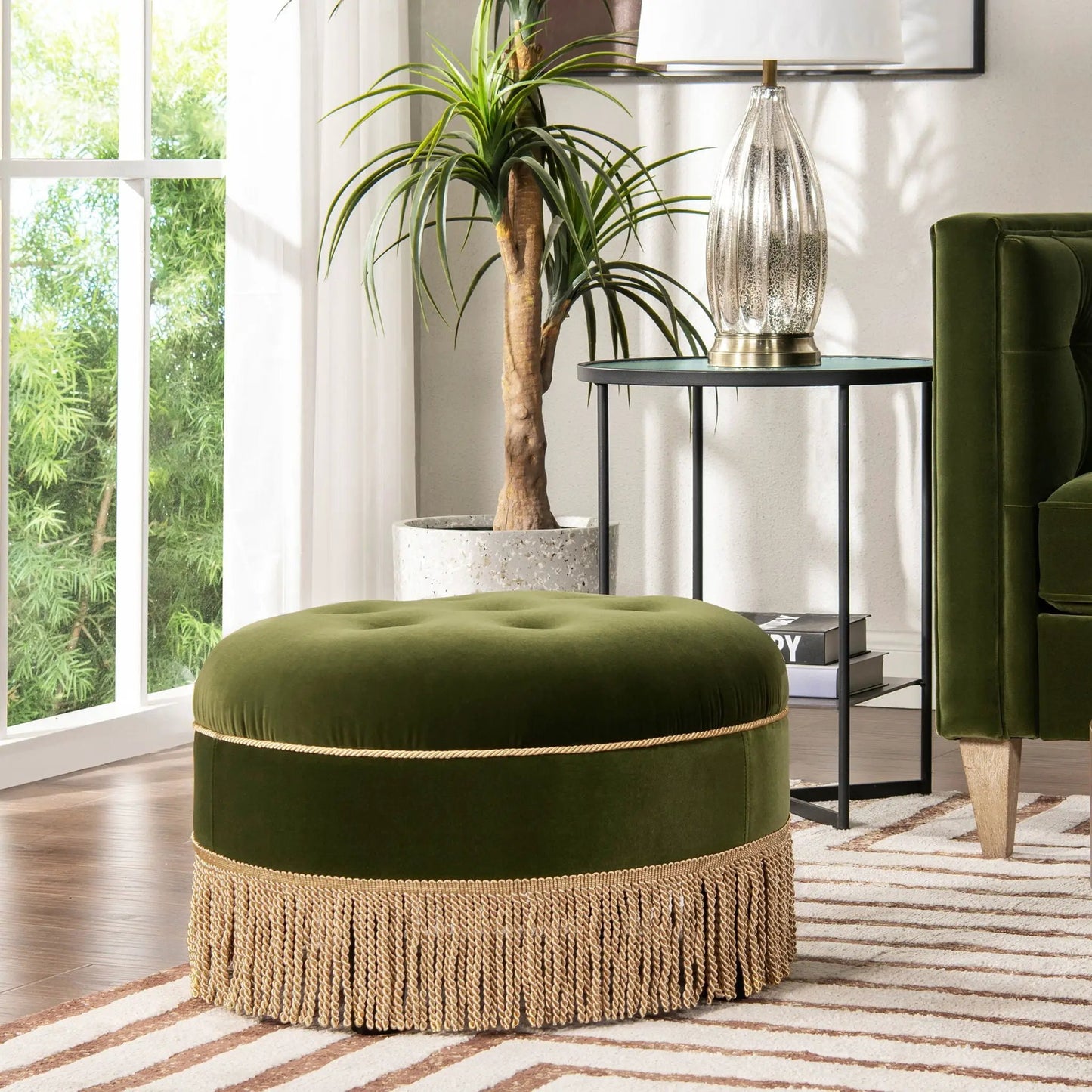 Yolanda round upholstered accent ottoman in emerald green velvet with natural jute fringe base on Tampa Home & Garden Store