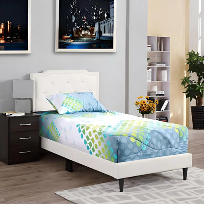 White button-tufted bed with black legs and blue-green bedding in a modern bedroom on Tampa Home & Garden Store