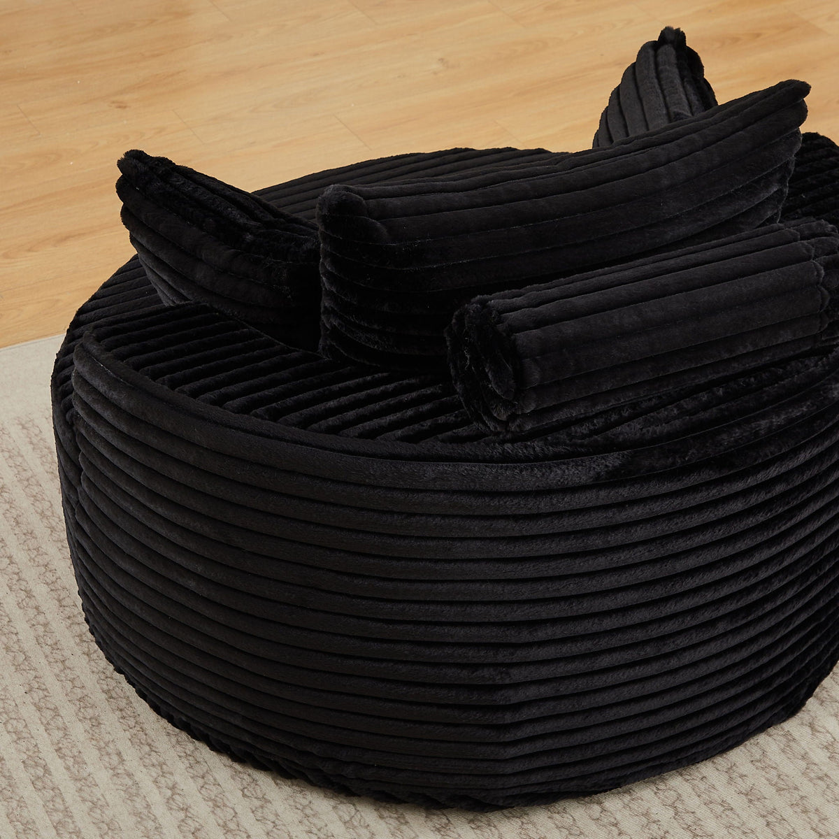 Modern single sofa with backrest pillow in black velvet, ribbed channel cushions on Tampa Home & Garden Store