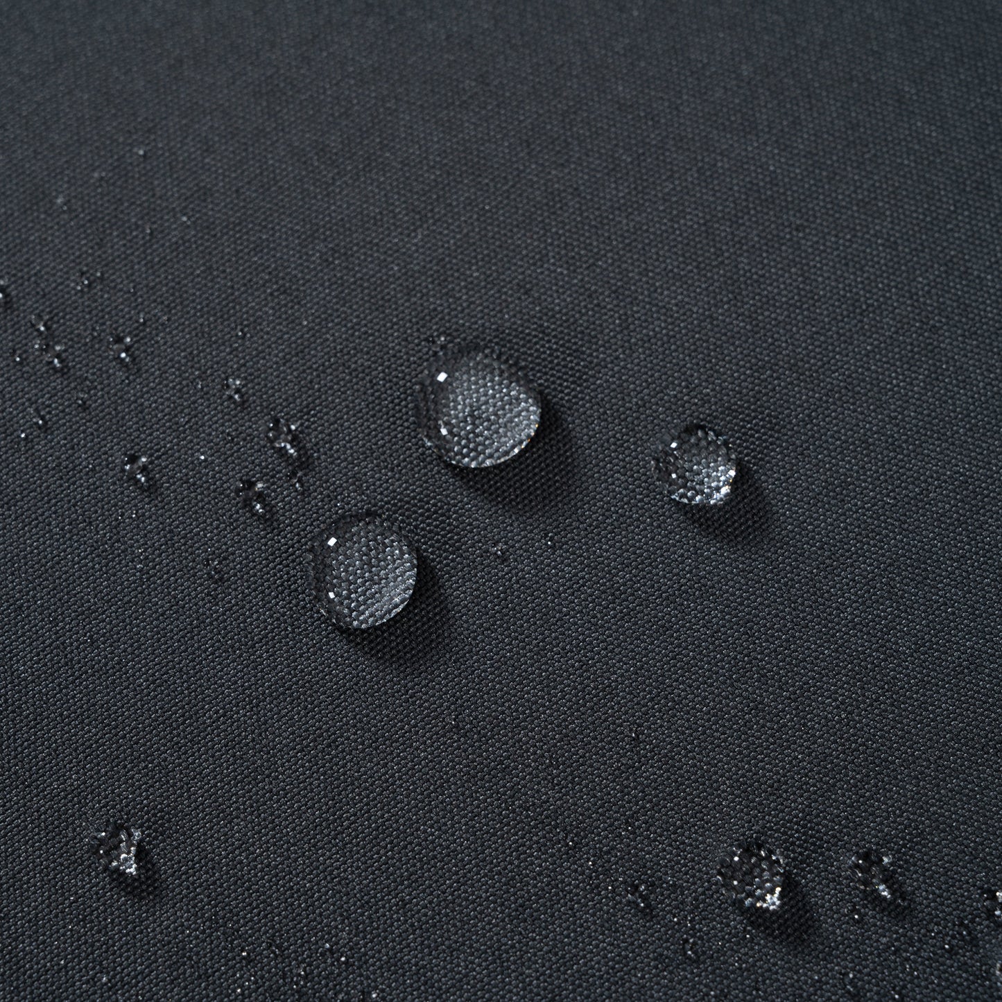 Outdoor sofas dark charcoal grey fabric closeup with water droplets on Tampa Home & Garden Store