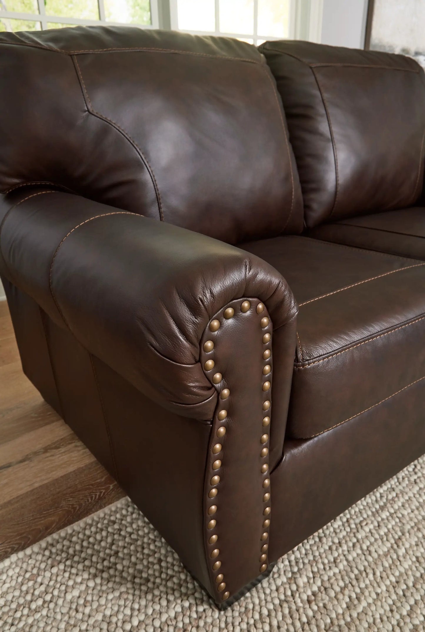 Colleton dark brown leather stationary sofa with padded arms and brass nailhead trim on Tampa Home & Garden Store