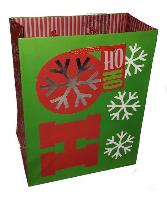Medium holiday gift bag green with red snowflake circle and Ho Ho Ho Flakes lettering, red braided handles on Tampa Home & Garden Store