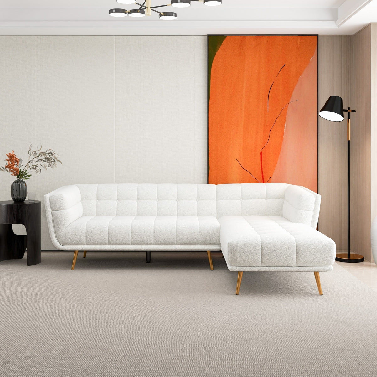 White L-shaped tufted sectional sofa with mid-century gold legs in a contemporary living room on Tampa Home & Garden Store