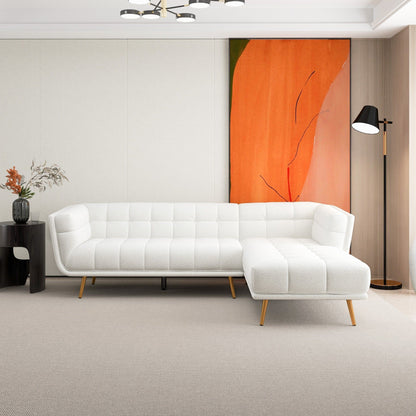 White L-shaped tufted sectional sofa with mid-century gold legs in a contemporary living room on Tampa Home & Garden Store