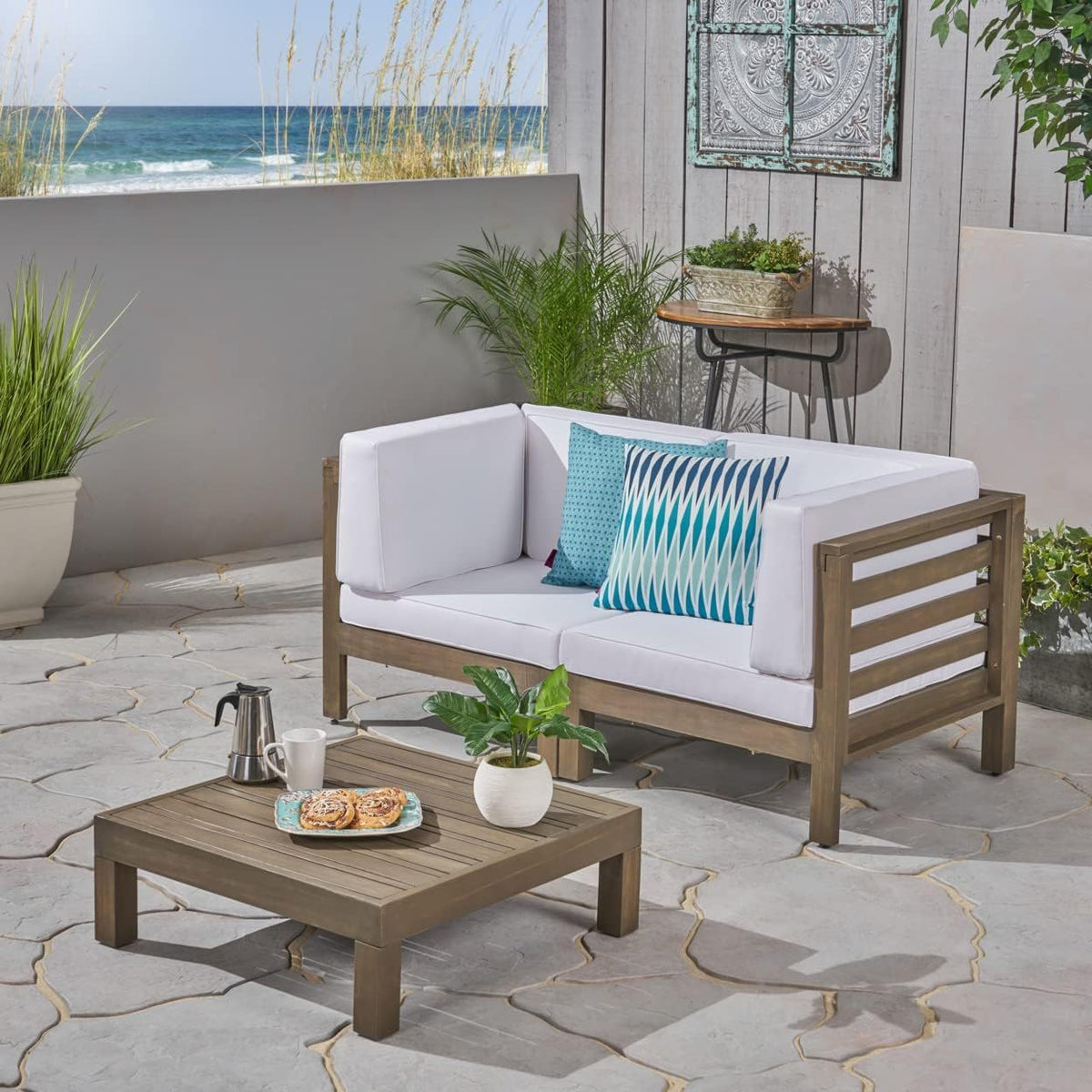 Oana 3 Piece Loveseat Set with Coffee Table in acacia wood, white cushions and teal pillows on Tampa Home & Garden Store