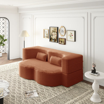 Convertible foam-filled sleeper sofa bed with 2 pillows in rust-orange ribbed fabric on Tampa Home & Garden Store