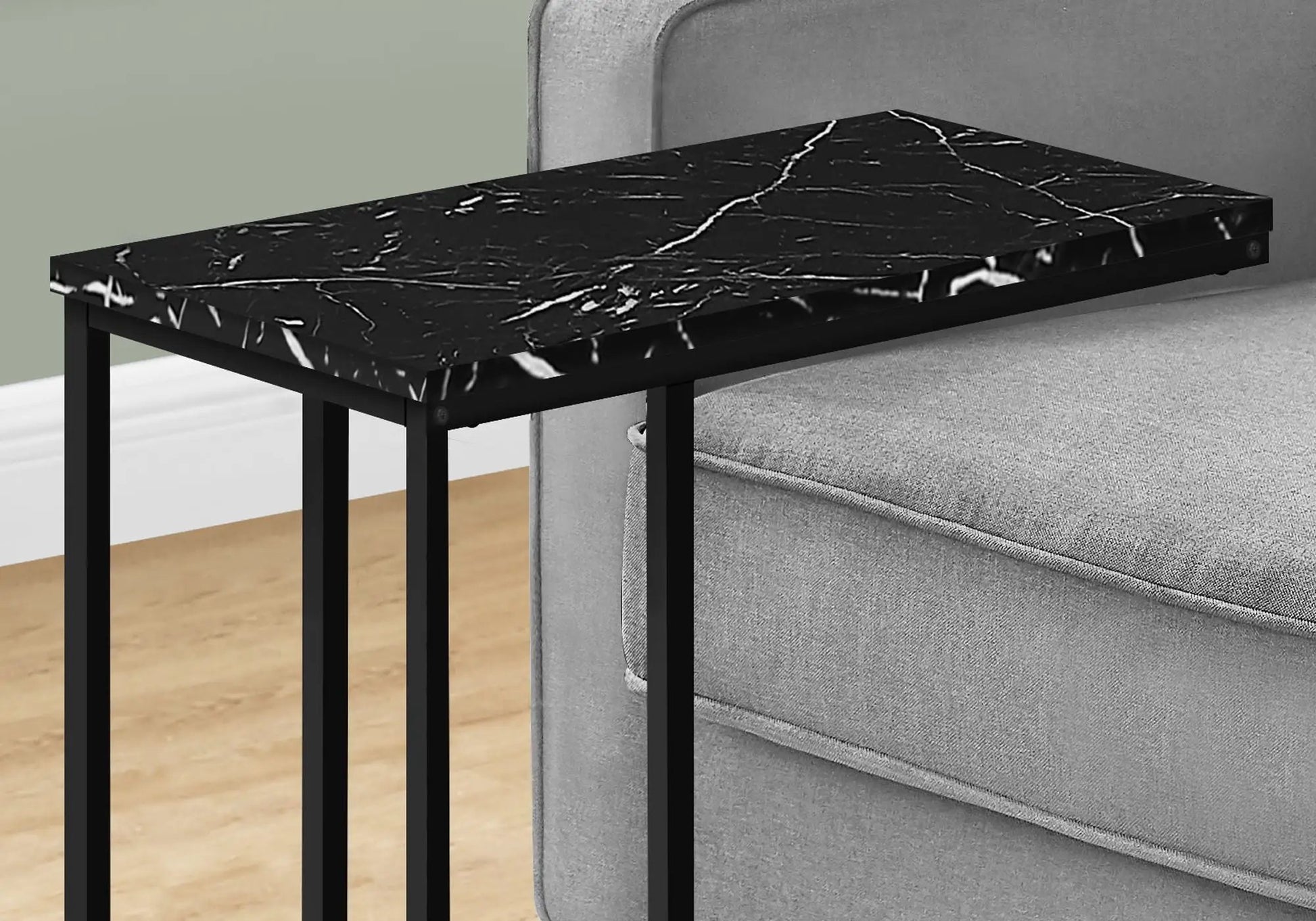 C-shaped marble-look black accent table with metal legs beside a grey sofa on Tampa Home & Garden Store