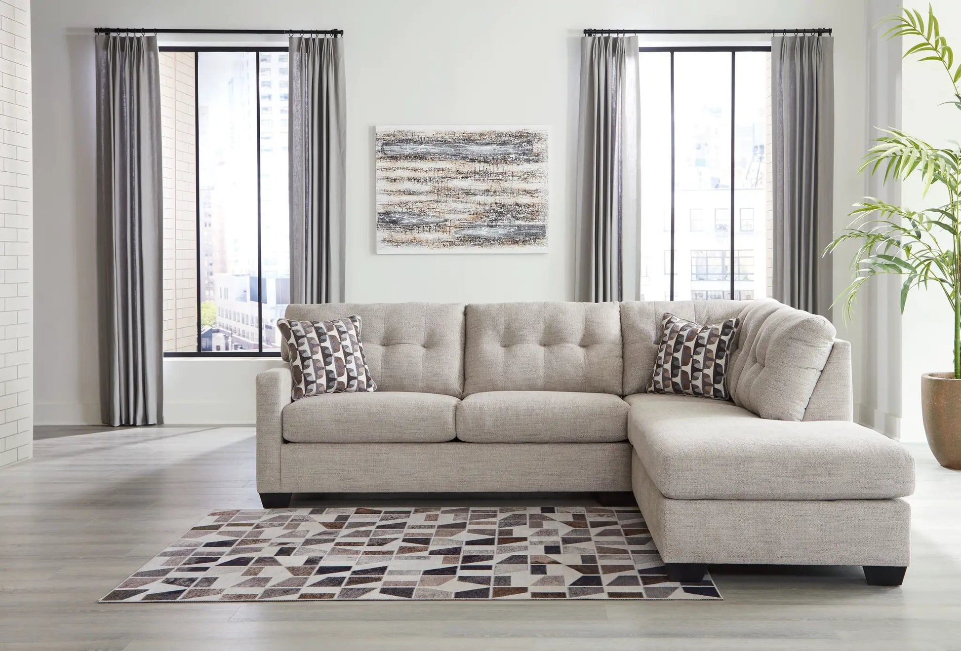 Mahoney Sectional beige fabric stationary sofa with chaise in a modern living room on Tampa Home & Garden Store