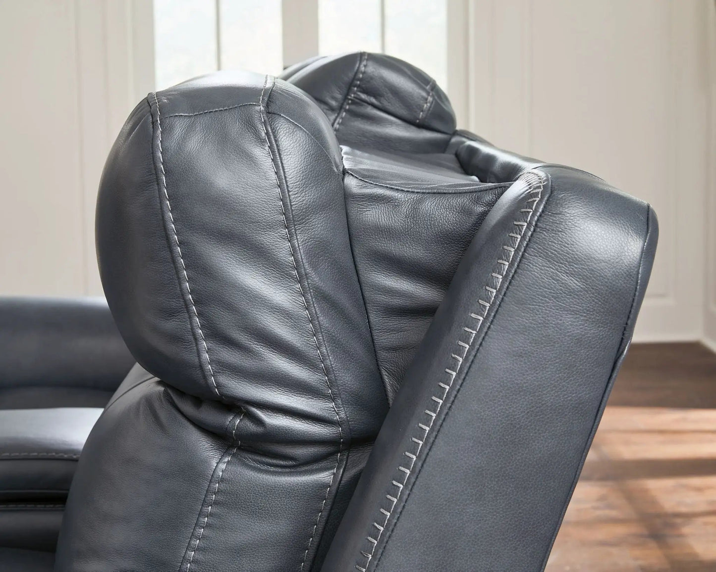 Bexhurst power reclining sofa in black leather with white stitching on Tampa Home & Garden Store