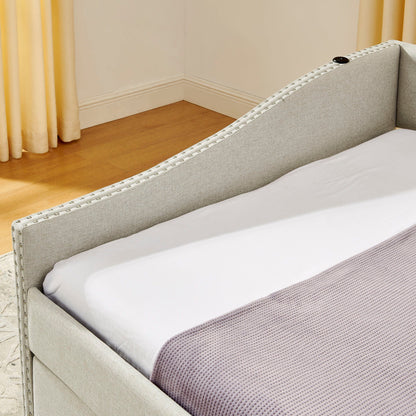 Upholstered daybed in light gray fabric with nailhead trim along edge on Tampa Home & Garden Store