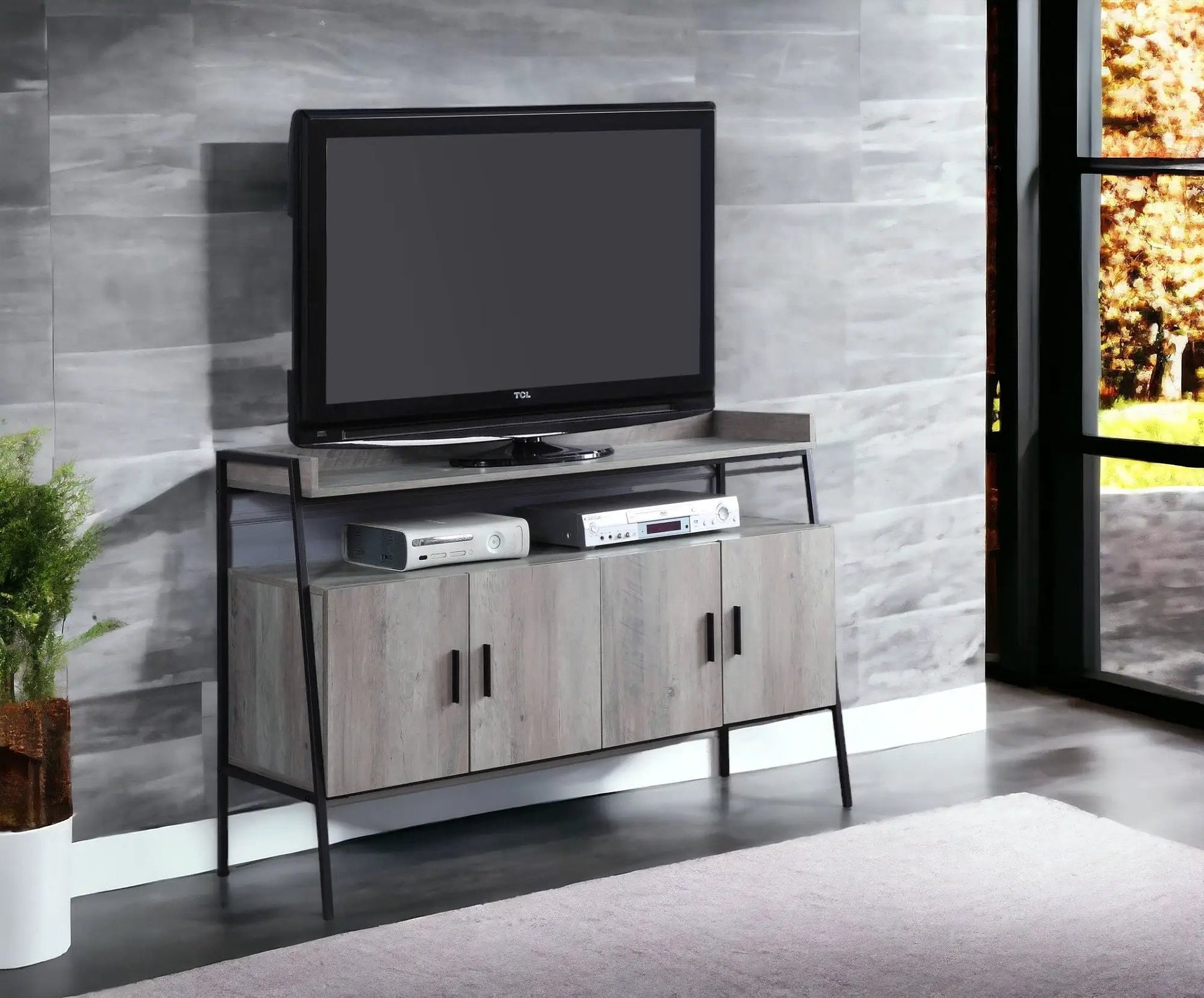 Samiya gray TV stand with light woodgrain cabinets and black metal legs supports a TCL TV on Tampa Home & Garden Store