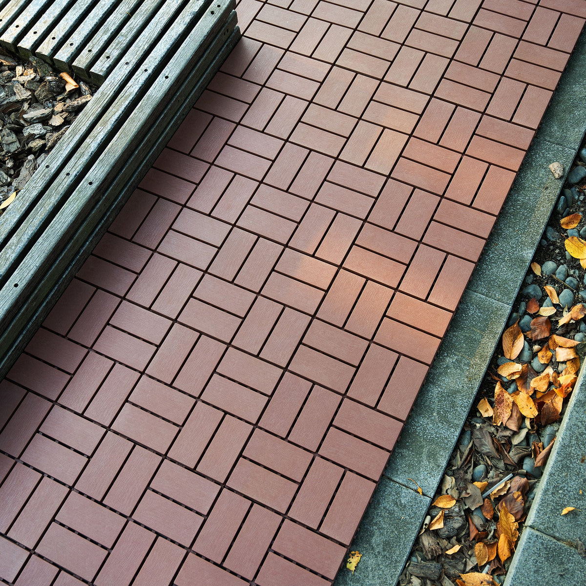 Interlocking deck tiles 44-pack in dark brown for easy installation, laid on a patio on Tampa Home & Garden Store