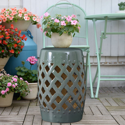 Ceramic garden stool with woven lattice cutouts in blue-green glaze topped by beige planter on Tampa Home & Garden Store