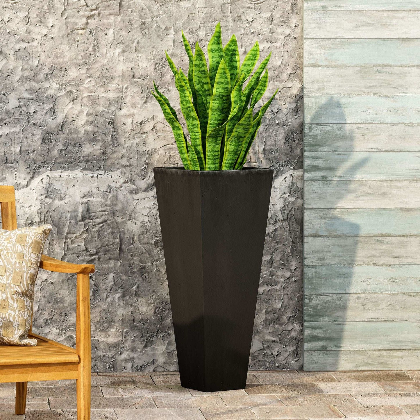 Outdoor Modern Cast Stone Planter tall black planter with green snake plant against wall on Tampa Home & Garden Store