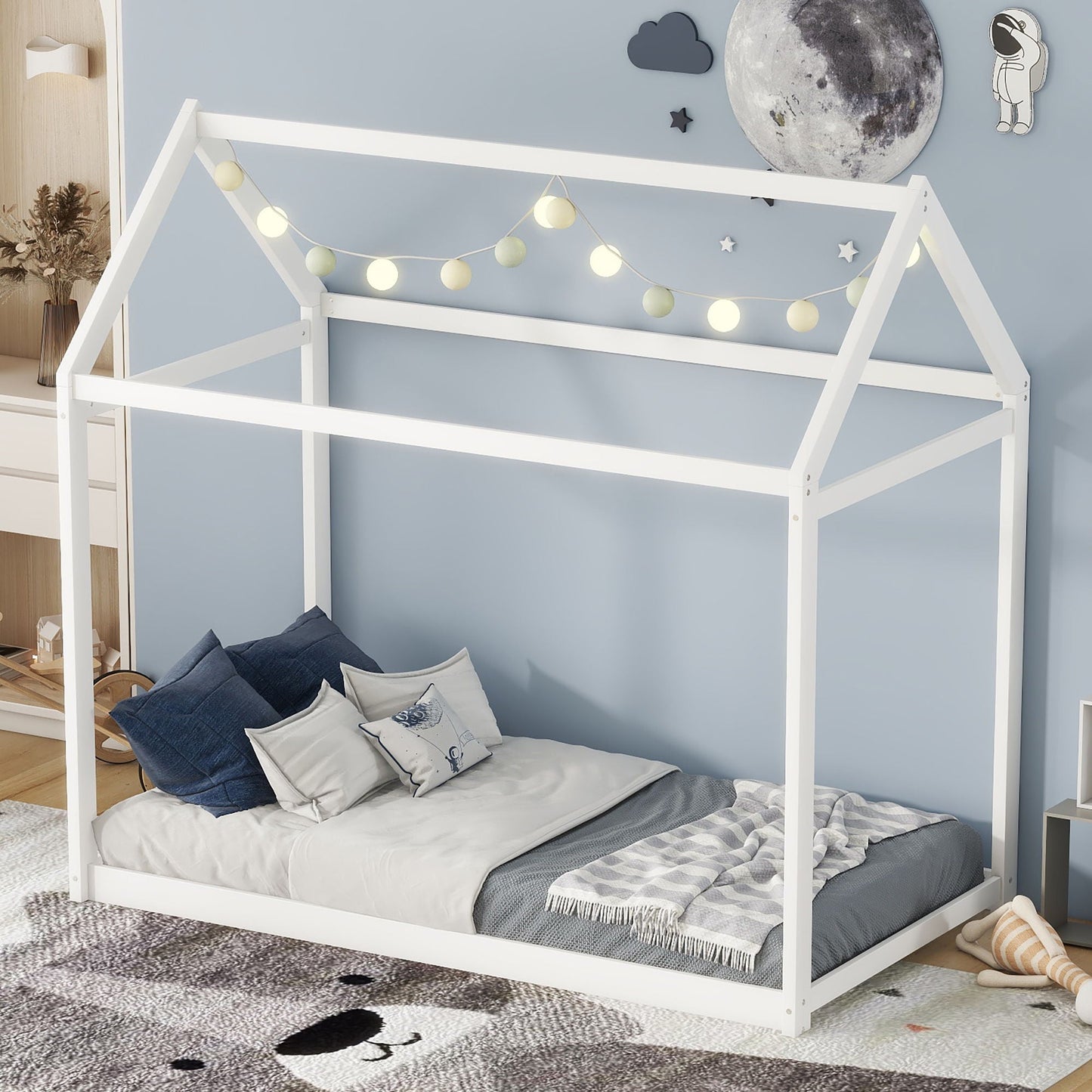 Wooden house-shaped twin platform bed by HouseOfZazla, white frame with string lights on Tampa Home & Garden Store