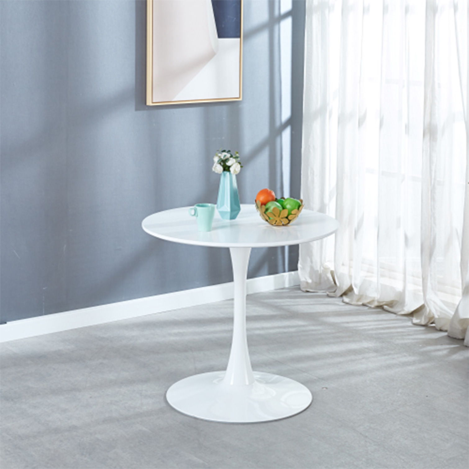 Mid-Century Tulip Table with Round White Top and Pedestal Base in blue-walled room on Tampa Home & Garden Store