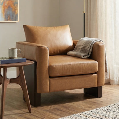 Modern Accent Chair in tan faux leather with rubberwood legs shown with a round wood side table on Tampa Home & Garden Store