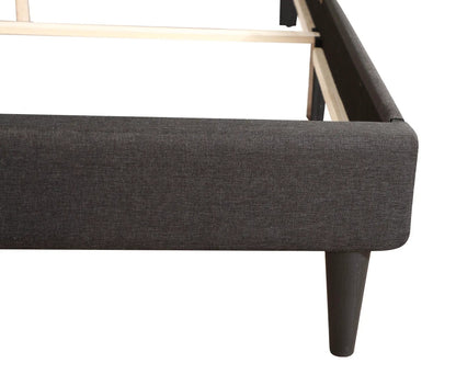 Button tufted bed upholstered in dark charcoal fabric with wooden legs on Tampa Home & Garden Store