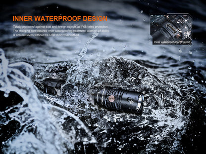 Fenix PD36R V2 compact tactical flashlight on wet rocks; black aluminum, 1700 lumens on Tampa Home & Garden Store