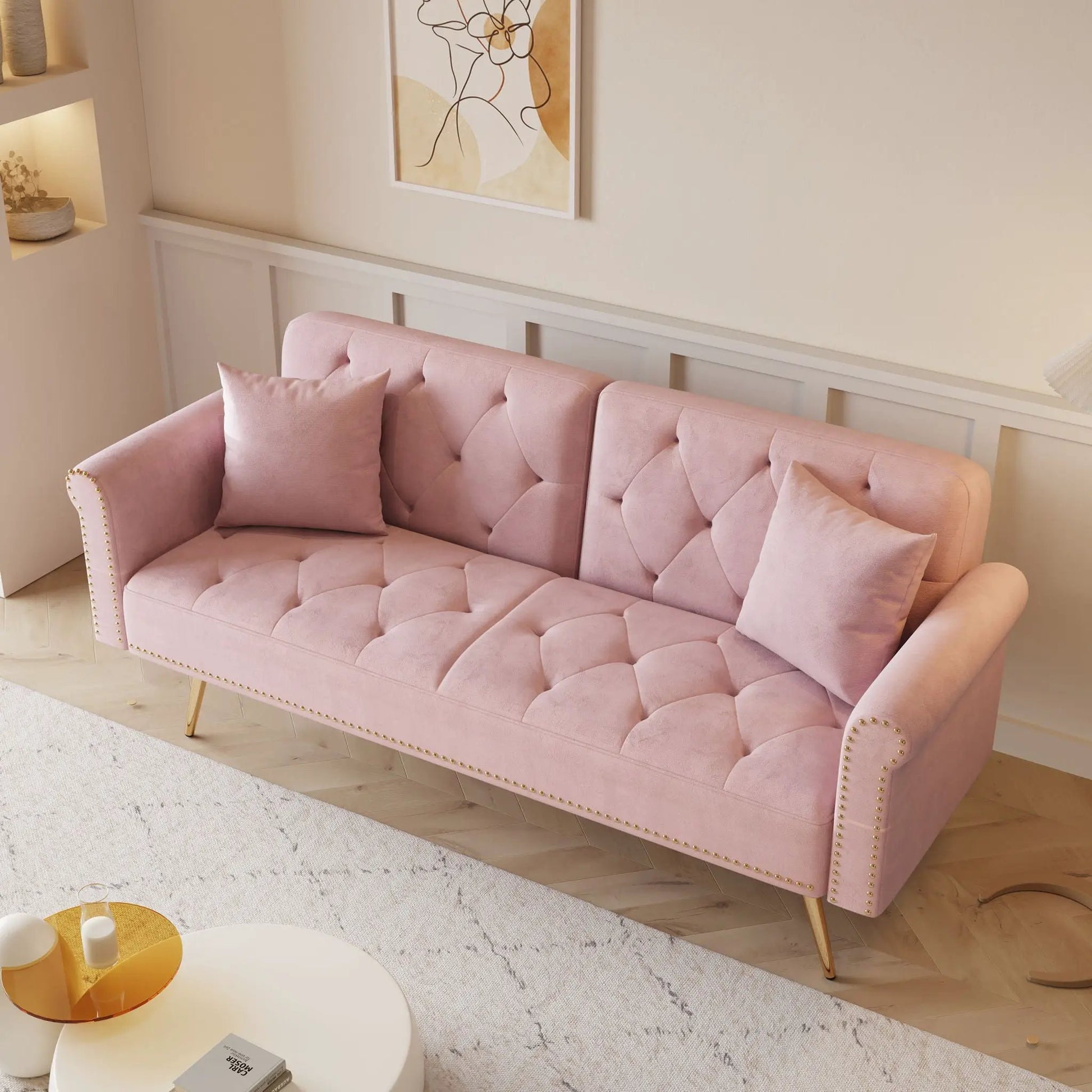 Luxurious pink velvet futon sofa bed with nail head trim and matching pillows on Tampa Home & Garden Store